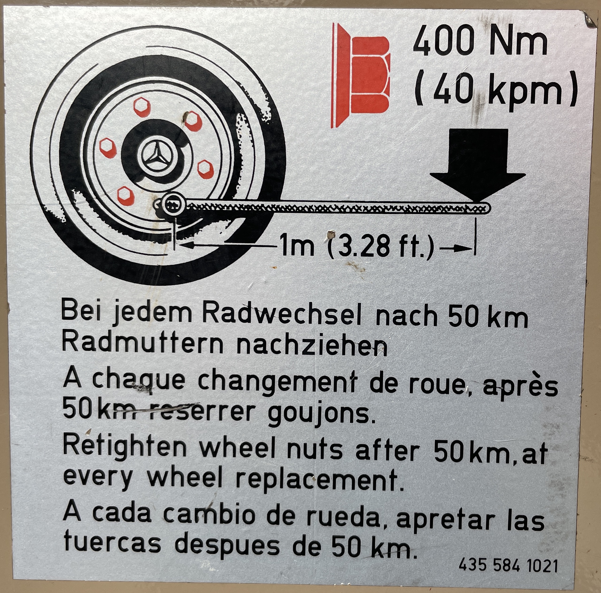 Original faded Mercedes Unimog wheel torque warning label in four languages