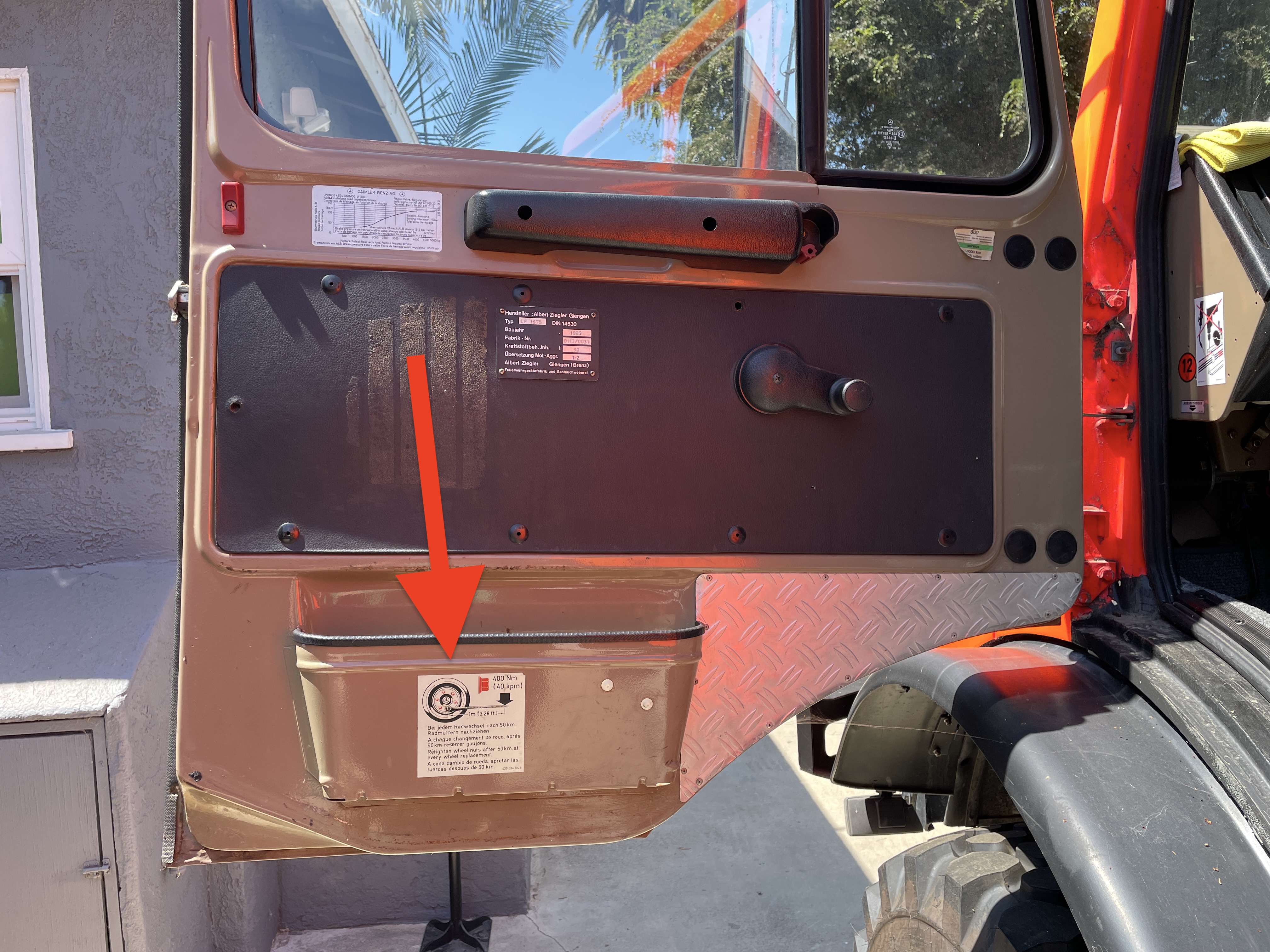 Location of wheel torque decal on Unimog 435 driver side door pocket